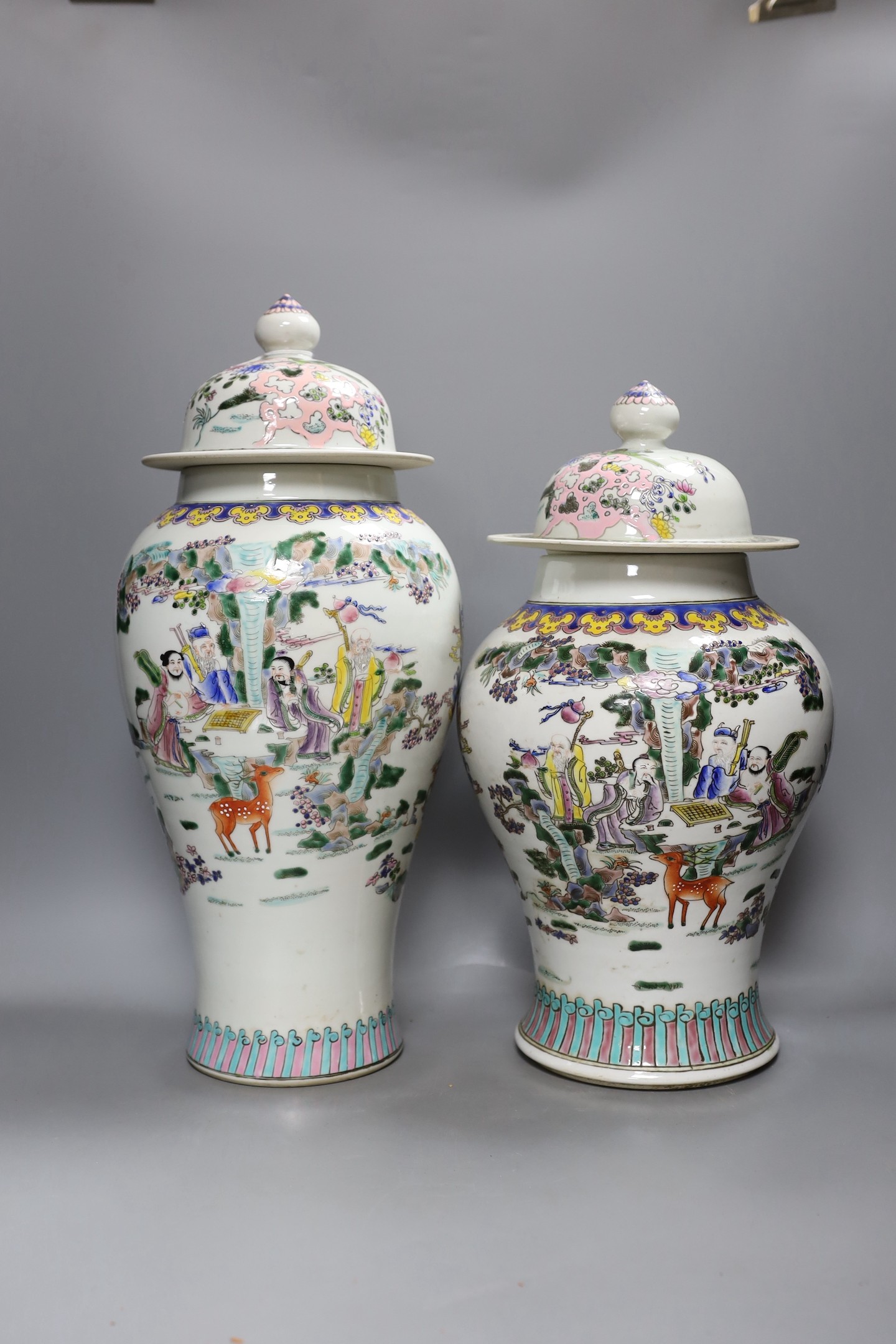 Two Chinese famille rose vases and covers, tallest 46cm high